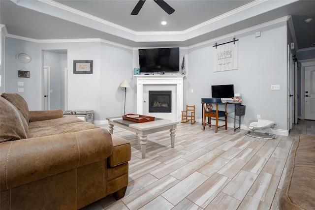 living room with crown molding, light hardwood / wood-style flooring, and ceiling fan