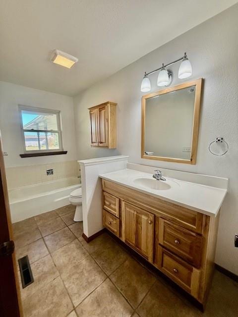 bathroom with tile patterned floors, vanity, and toilet