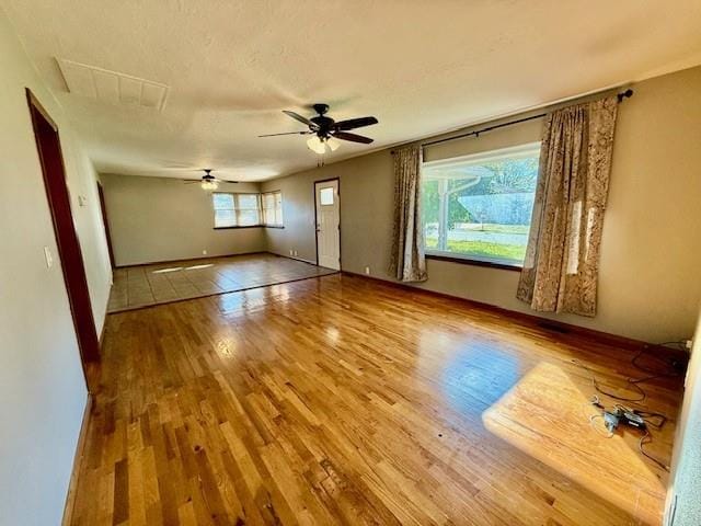 unfurnished room with ceiling fan and wood-type flooring