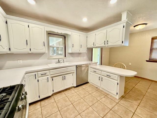 kitchen with kitchen peninsula, white cabinetry, sink, and stainless steel appliances