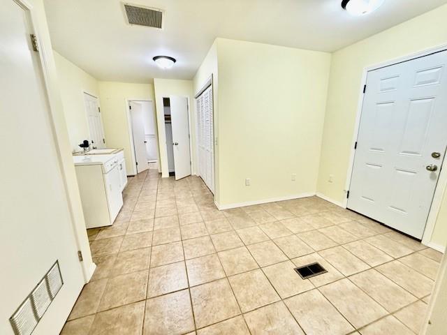 foyer featuring sink and light tile patterned flooring