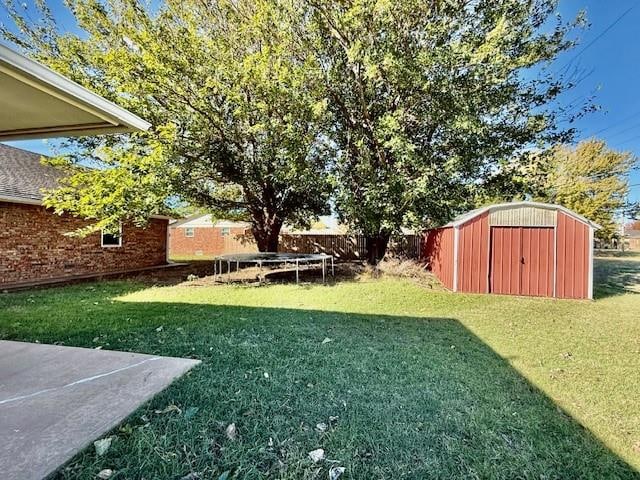 view of yard with a storage unit, a patio area, and a trampoline