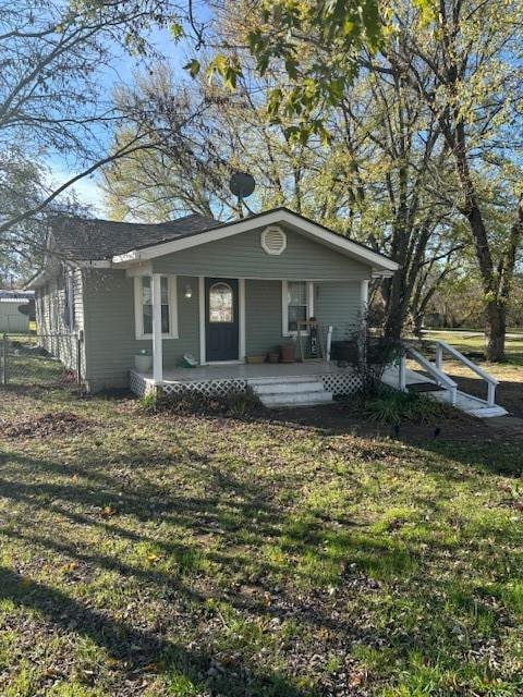 ranch-style house featuring a front yard and a porch