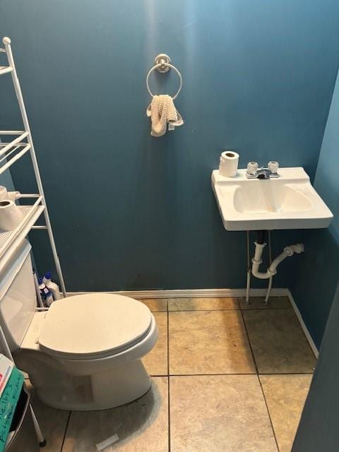 bathroom with tile patterned floors, sink, and toilet