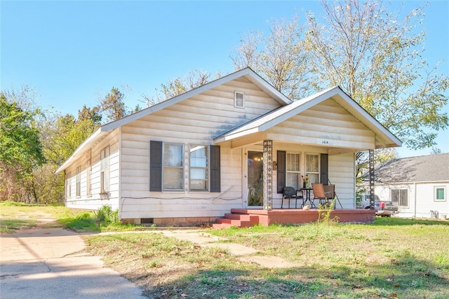 bungalow-style home with a front yard and a porch