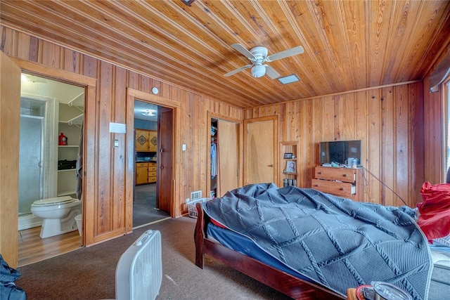 carpeted bedroom featuring ensuite bath, ceiling fan, a closet, and wood ceiling