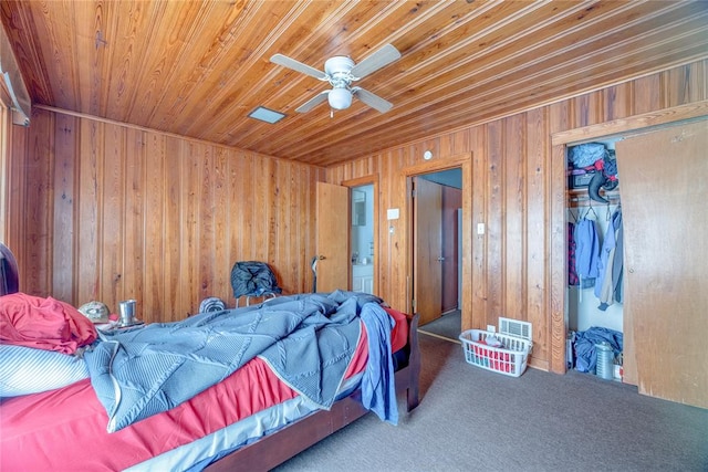 carpeted bedroom with wood ceiling, ceiling fan, and wood walls