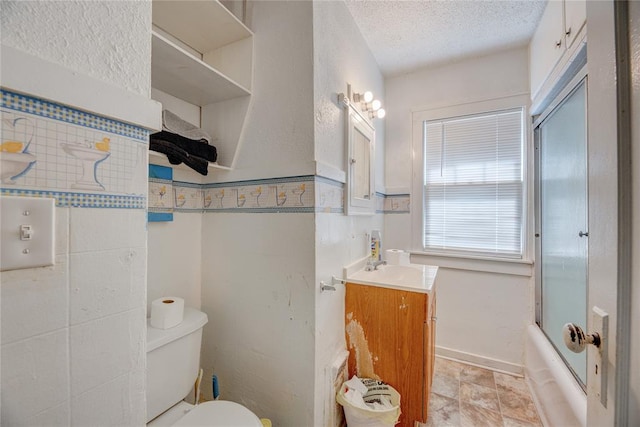 full bathroom featuring vanity, toilet, enclosed tub / shower combo, and a textured ceiling