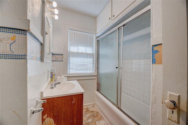 bathroom featuring vanity and bath / shower combo with glass door