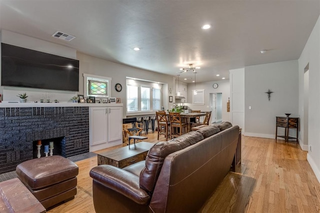 living room featuring a fireplace and light hardwood / wood-style floors