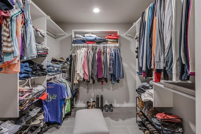 spacious closet with light tile patterned floors