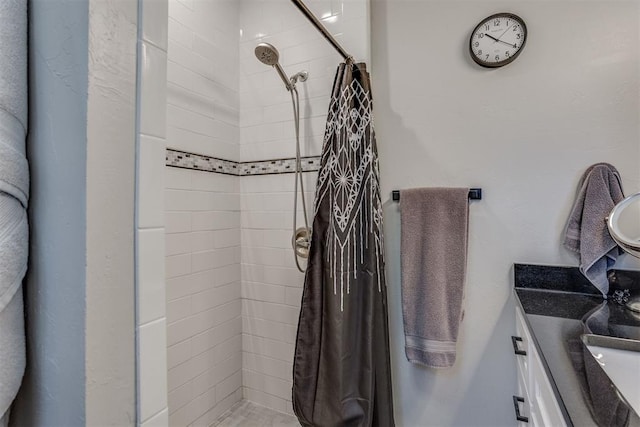 bathroom with curtained shower and vanity