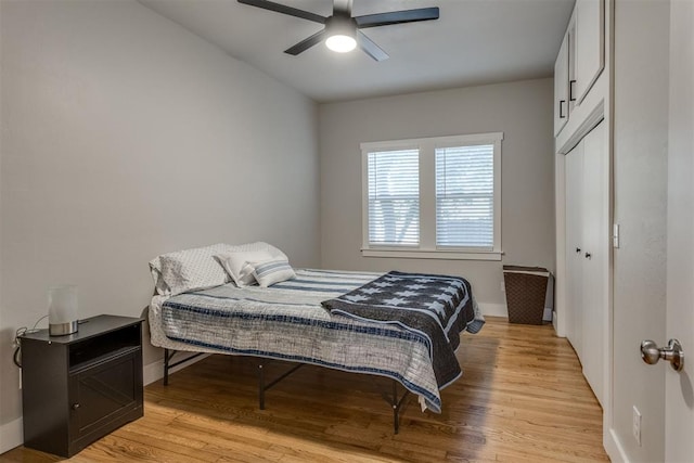 bedroom featuring a closet, light hardwood / wood-style floors, and ceiling fan