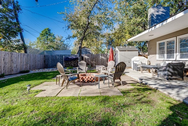 view of patio / terrace with area for grilling, a shed, and an outdoor fire pit