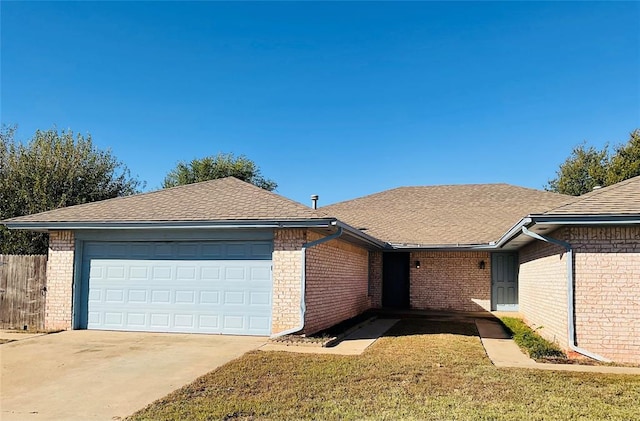 ranch-style home featuring a garage and a front lawn