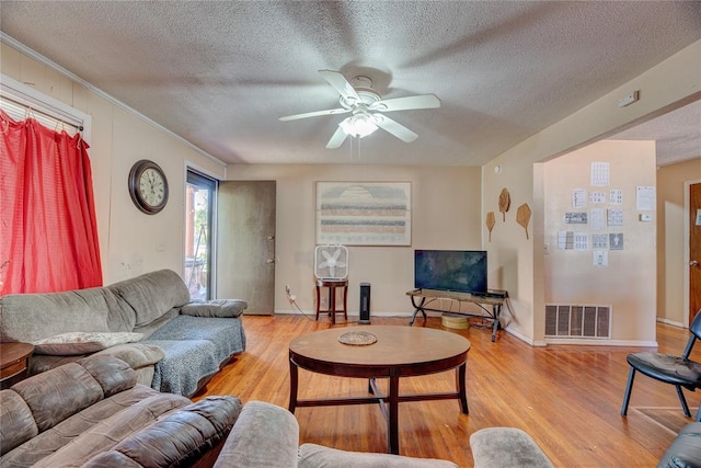 living room with light wood-type flooring and a textured ceiling