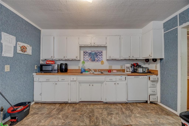 kitchen featuring dishwasher, a textured ceiling, white cabinetry, and sink