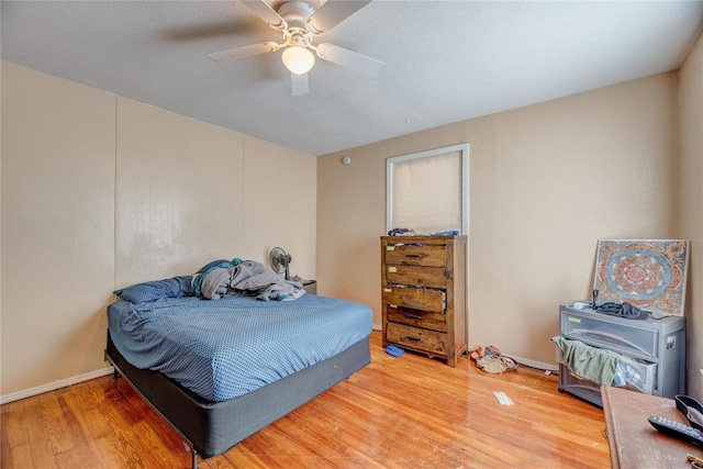 bedroom with hardwood / wood-style flooring and ceiling fan