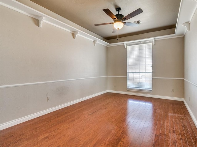 empty room with ceiling fan and hardwood / wood-style floors