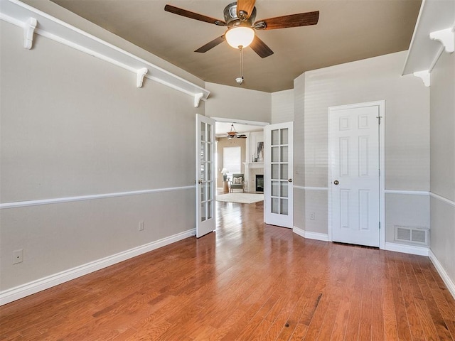 unfurnished room with french doors and wood-type flooring