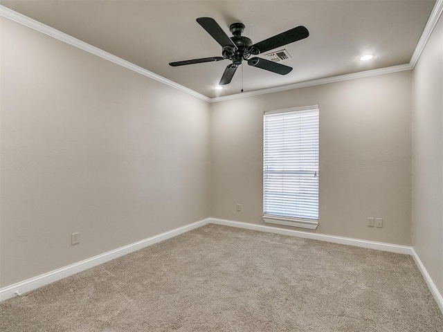 spare room with carpet, ceiling fan, and crown molding