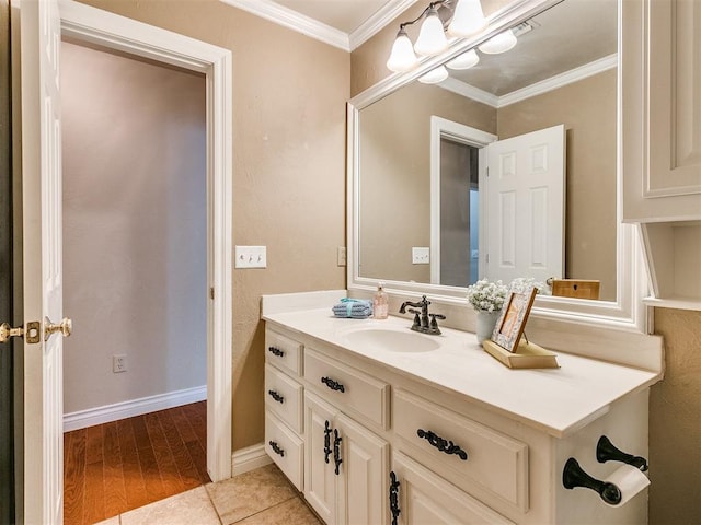 bathroom with vanity, hardwood / wood-style flooring, and crown molding