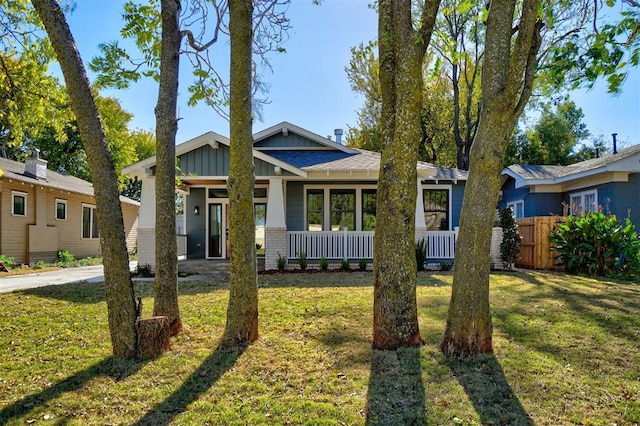 view of front of house featuring a front yard and covered porch