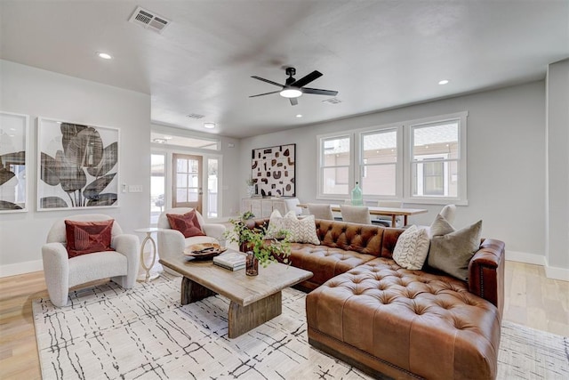 living room featuring ceiling fan and light wood-type flooring