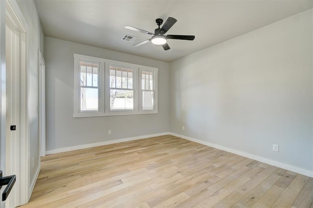 empty room with ceiling fan and light hardwood / wood-style flooring