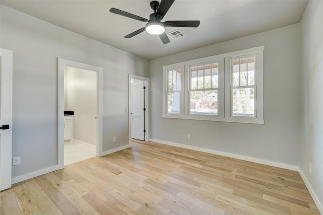 unfurnished bedroom with connected bathroom, ceiling fan, and light hardwood / wood-style flooring