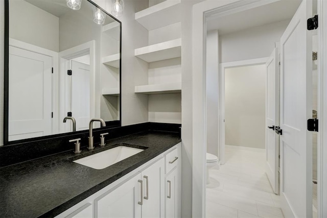 bathroom with tile patterned floors, vanity, and toilet