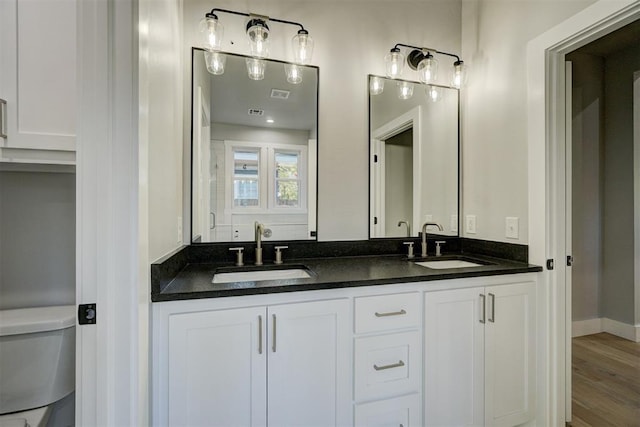 bathroom with vanity, hardwood / wood-style floors, and toilet