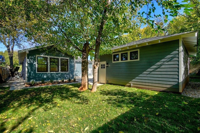 rear view of house with a yard