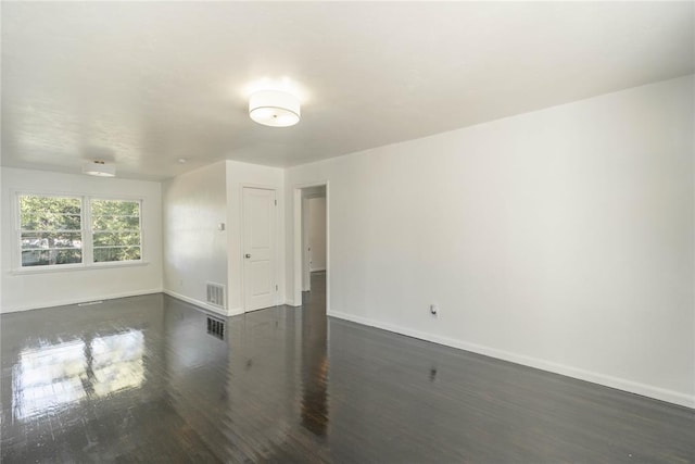 empty room with dark hardwood / wood-style floors