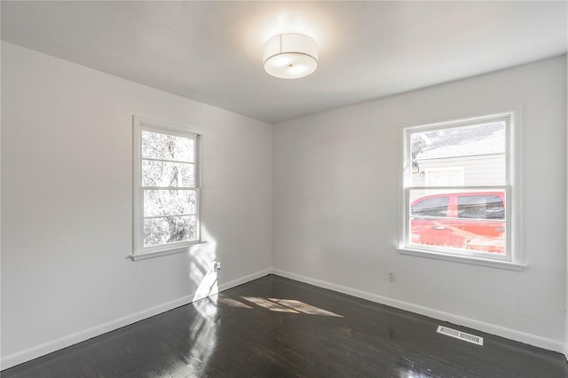 unfurnished room featuring dark hardwood / wood-style floors