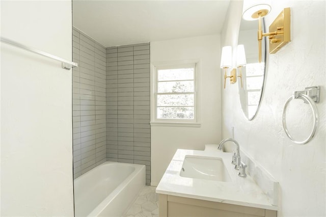 bathroom featuring vanity and tiled shower / bath combo