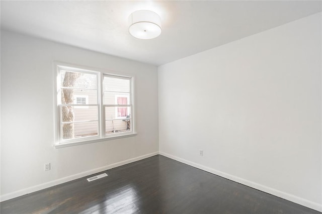 spare room with dark hardwood / wood-style flooring