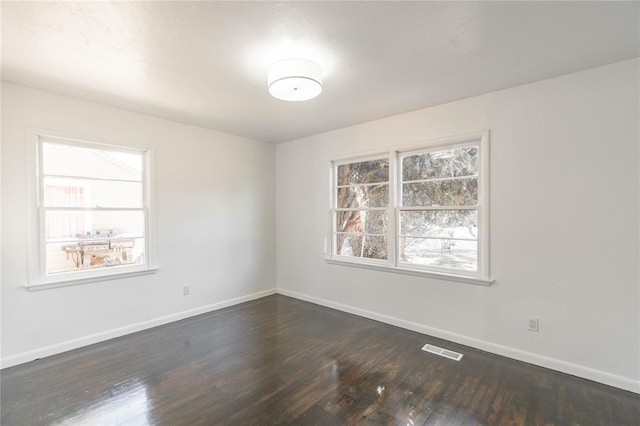 empty room featuring dark hardwood / wood-style floors