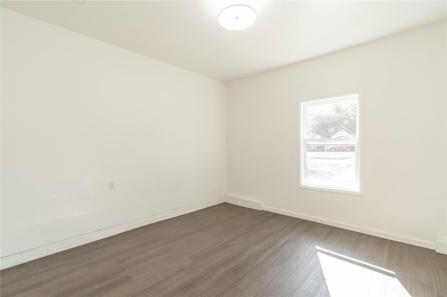 spare room featuring dark hardwood / wood-style floors