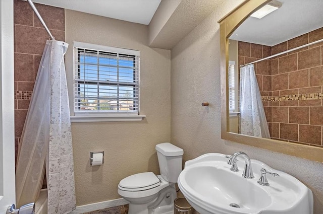 bathroom featuring sink and toilet