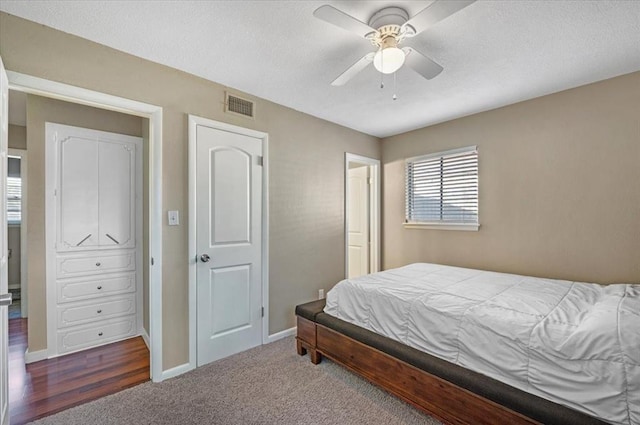 bedroom featuring ceiling fan and dark carpet