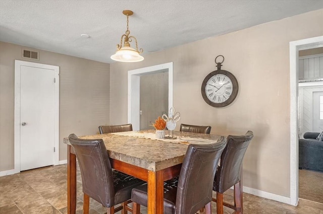 dining area with a textured ceiling