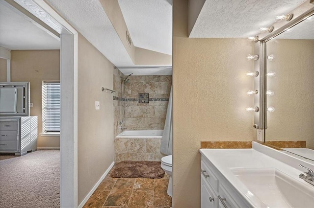 full bathroom with tile patterned floors, a textured ceiling, toilet, vanity, and shower / tub combo