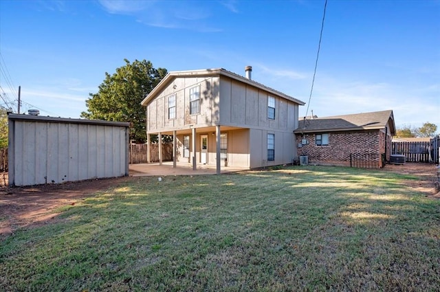 rear view of house with a yard, a patio area, and central air condition unit