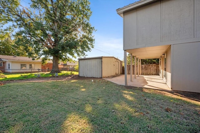 view of yard with a shed and a patio area