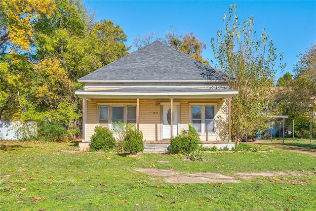 bungalow-style home featuring covered porch and a front yard