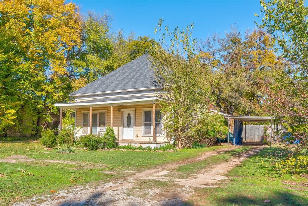 view of front of property with covered porch and a front yard