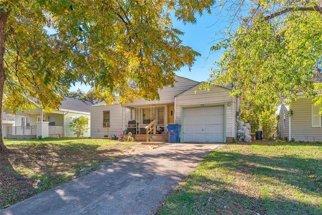 single story home featuring covered porch, a front yard, and a garage