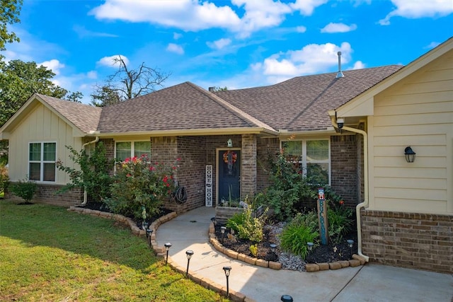 ranch-style home featuring board and batten siding, brick siding, roof with shingles, and a front lawn