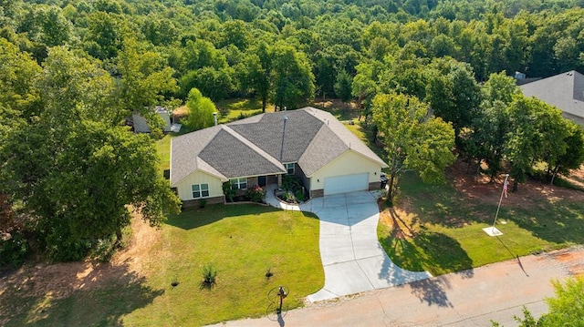 drone / aerial view with a wooded view